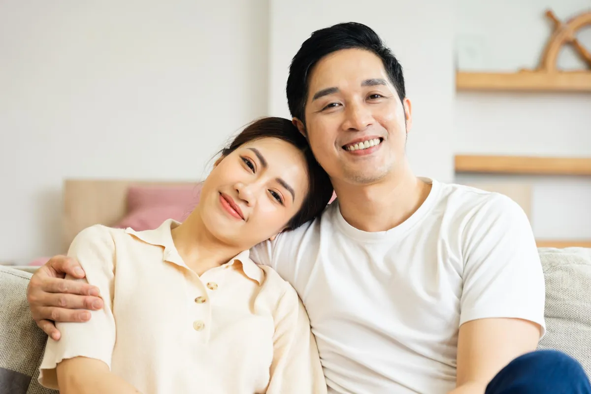 Cặp đôi Việt Nam trưởng thành ngồi bên nhau tại nhà